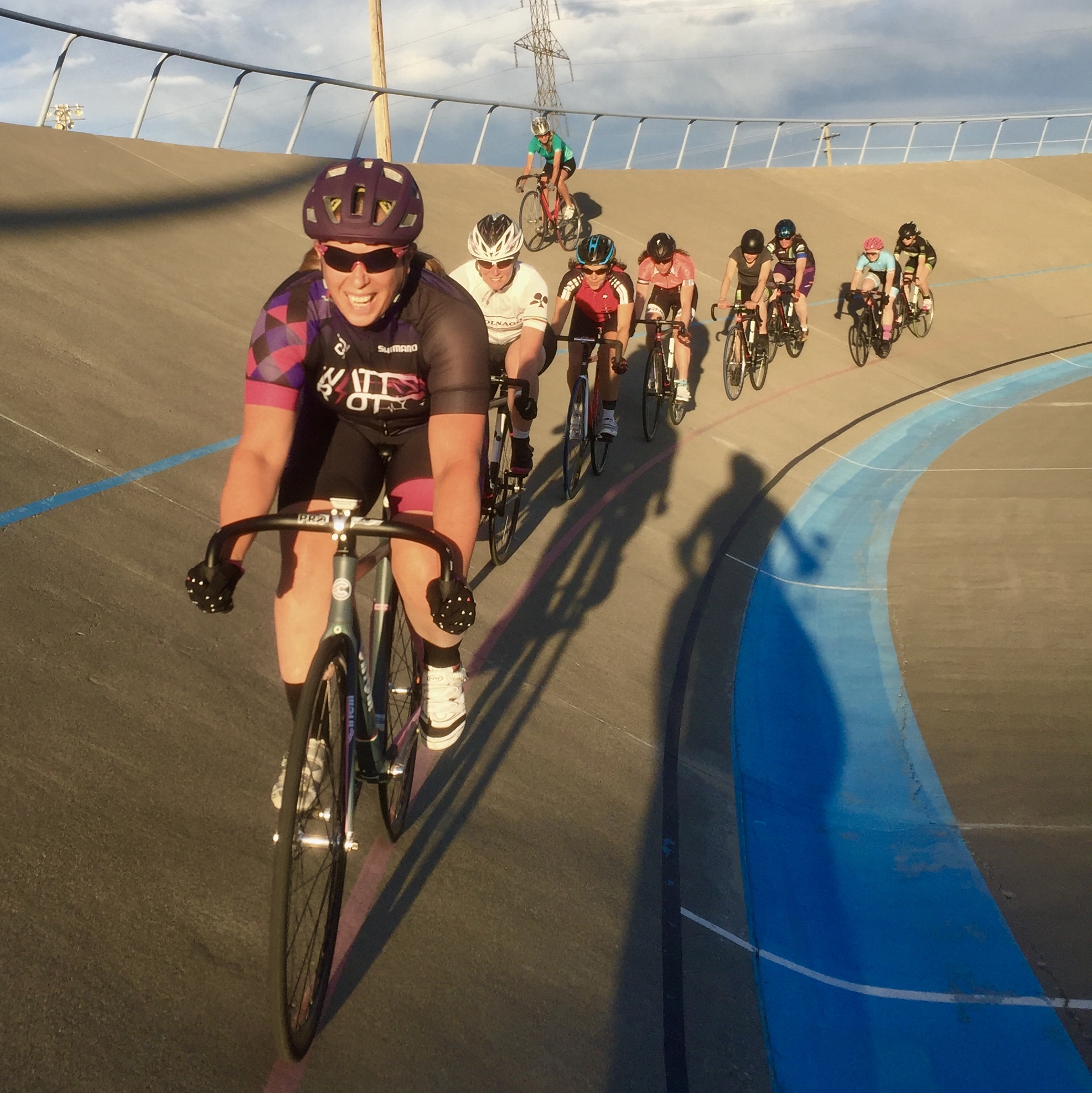 Kendra leading a group of women on bikes around the velodrome